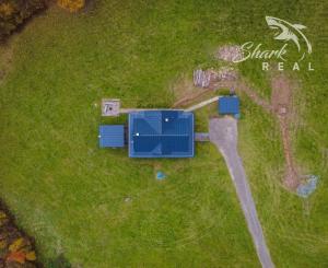 Krásna chata pod lesom s veľkým pozemkom.